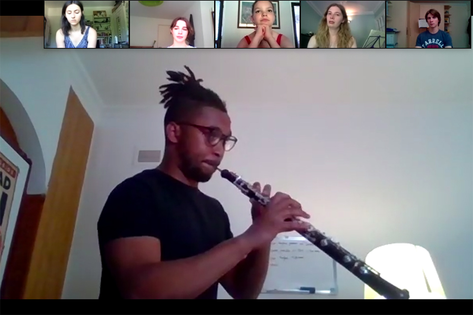 An RCM Woodwind student performs to classmates on Zoom